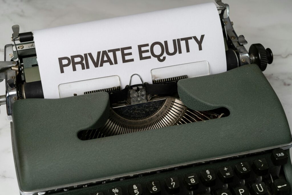 Close-up of vintage typewriter with 'PRIVATE EQUITY' on paper, business concept.