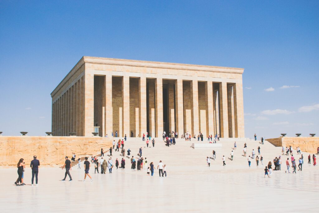 Visitors at Anıtkabir in Ankara, Turkey, under clear blue skies, highlighting architectural grandeur.